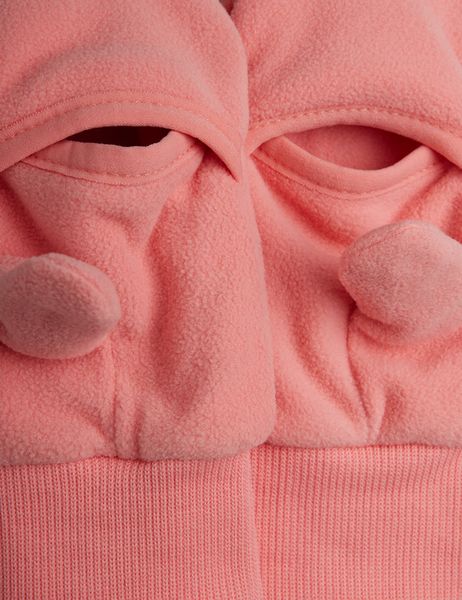 Close-up of pink microfleece mittens showing the overlapping cuff design, 3D details, and ribbed wrist bands.