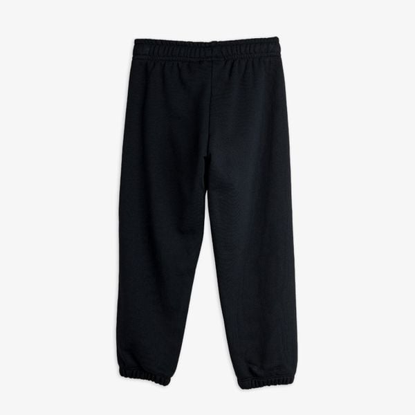 Black sweatpants shown from the back, featuring an elastic waistband and cuffs.