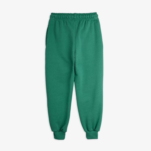 Green sweatpants featuring an elastic drawstring waist and ribbed cuffs.