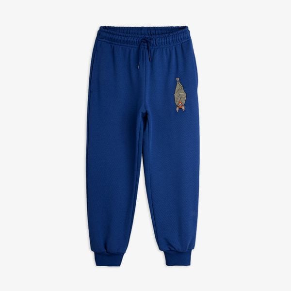 Blue sweatpants featuring an elastic waistband with a drawstring and a Bat embroidery on the leg.