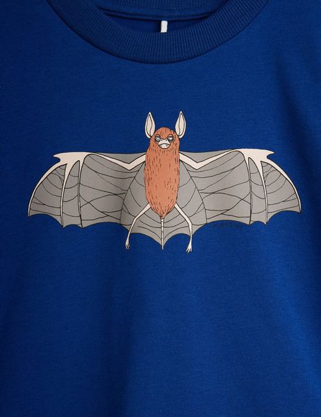 Close-up of a blue t-shirt featuring a detailed Bat print on the front.