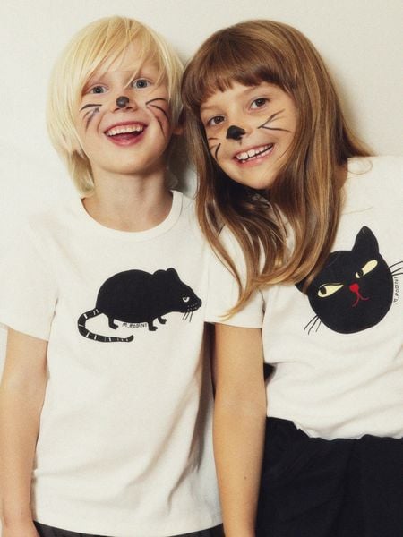 Off-white short-sleeved t-shirt featuring a black Cat print.
