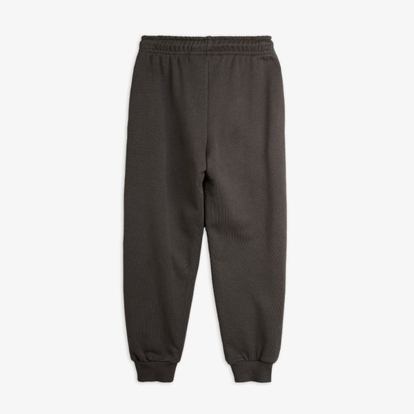 Grey sweatpants featuring an elastic waistband and ribbed cuffs, shown from the back.