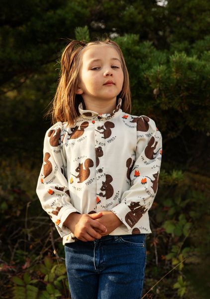 Off-white flannel blouse featuring an all-over brown Squirrel print, high frilled neck, and puffed sleeves.