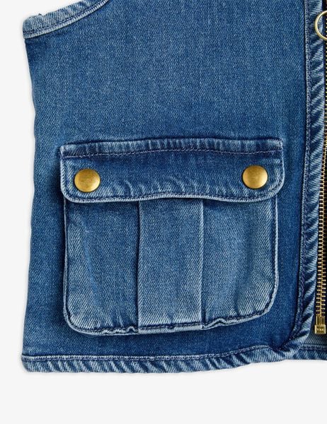 Denim utility vest with pockets and patches for kids, made from certified organic cotton.