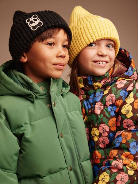 Black ribbed beanie featuring a Panda patch on the front, worn by a child.