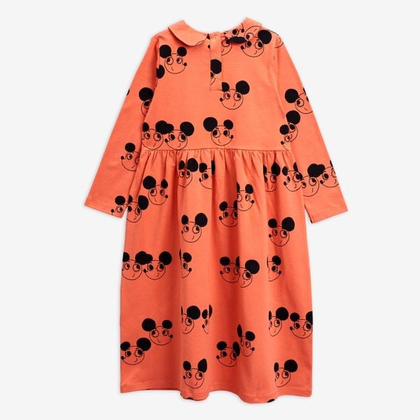 Orange long-sleeve dress featuring a black Ritzratz print, rounded collar, and button closure at the back.